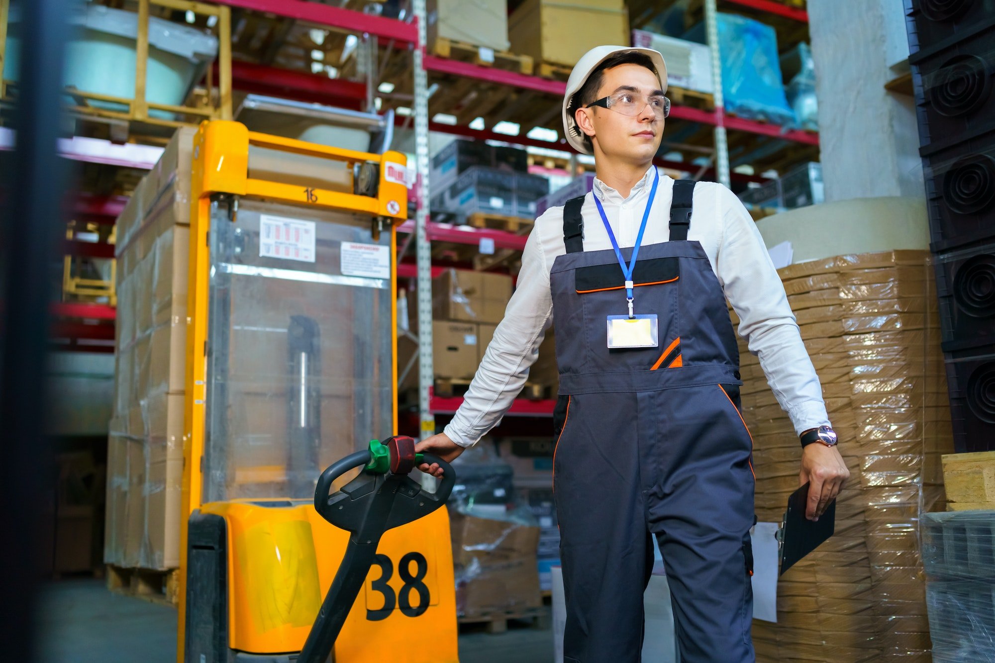 Man works in a warehouse with a forklift