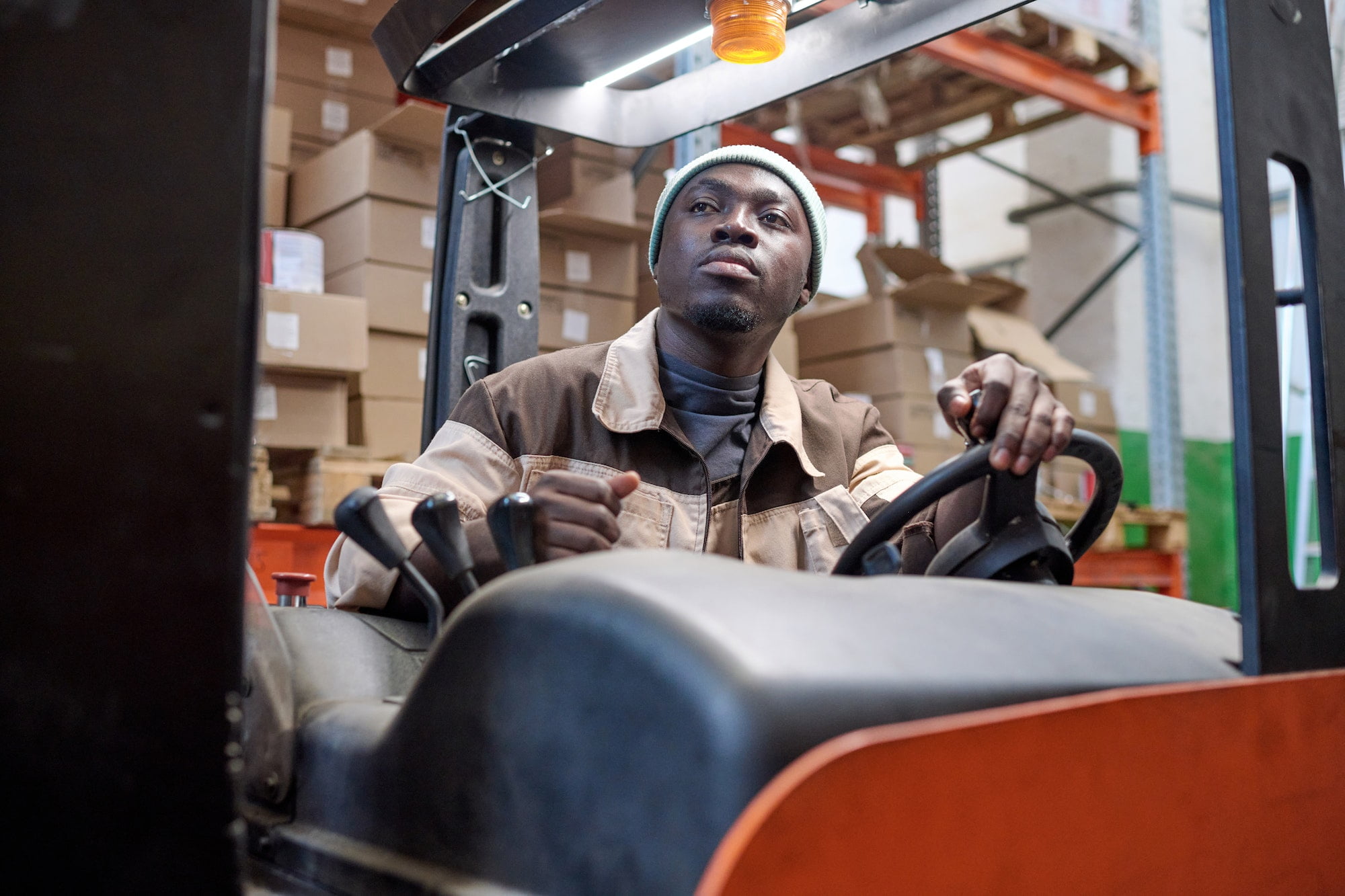 Warehouse worker driving in forklift