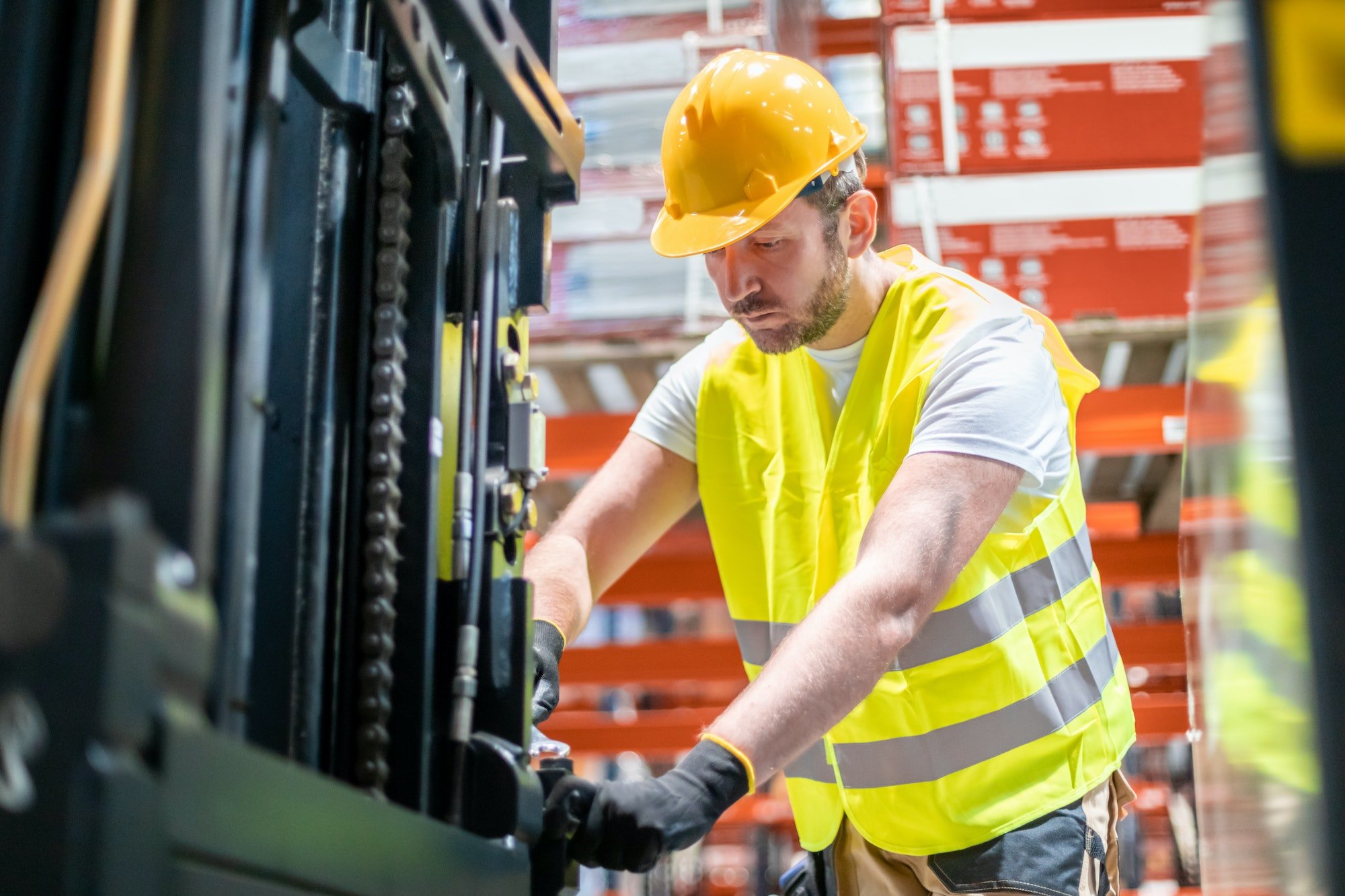 Mechanic repairing forklift in warehouse