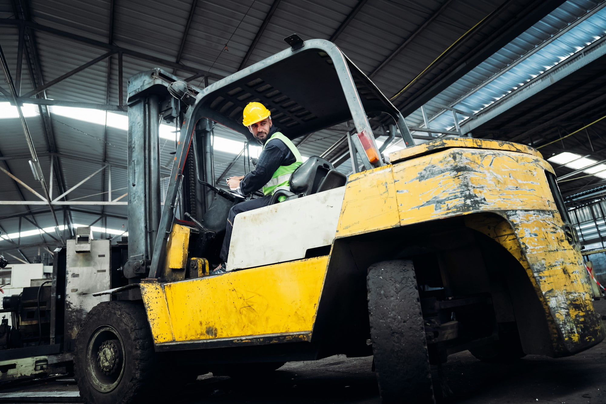 Industrious Engineer Operating Forklift in Warehouse. Efficient Forklift Driving in Factory.